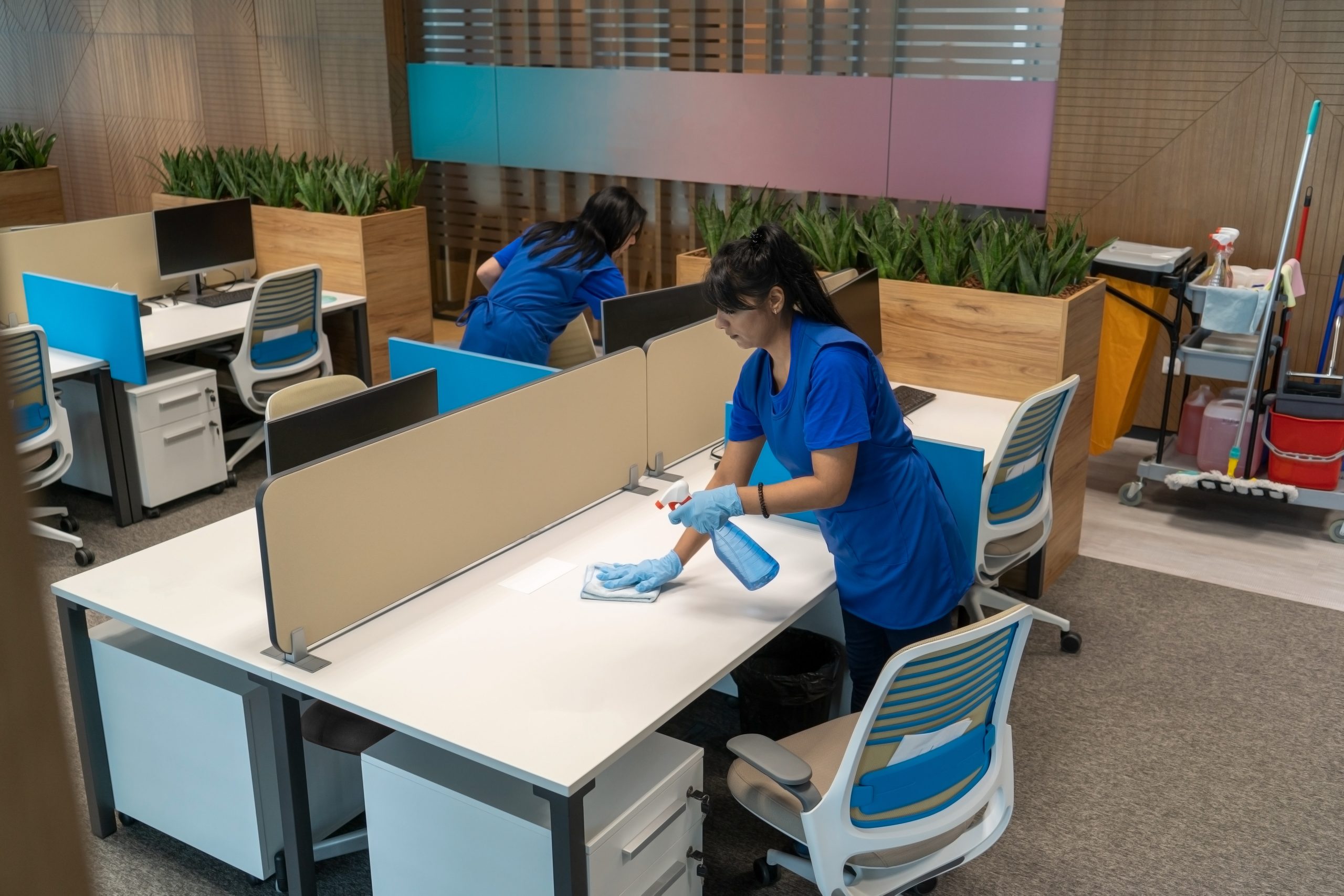 Cleaning Ladies Clean Desks In An Empty Office Space.cleaning Ma